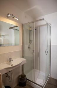 a bathroom with a glass shower and a sink at LH Hotel Andreotti in Rome