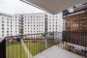 a balcony with a view of a building at Wola Sunset Apartment FREE Parking in Warsaw