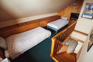 Voodi või voodid majutusasutuse Šumava Inn toas