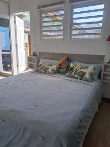 a large bed with two pillows on top of it at Tropical in Orient Bay French St Martin