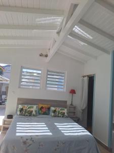a bedroom with a large bed in a white room at Tropical in Orient Bay French St Martin