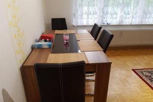 a dining room table with chairs and a table at 2 Rooms Apartment in Triberg in Triberg