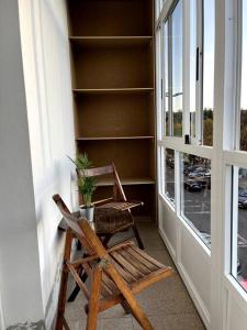 a chair sitting on a porch next to a window at El apartamento de Ordes in Órdenes