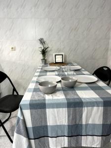 a blue and white table with three bowls on it at El apartamento de Ordes in Órdenes