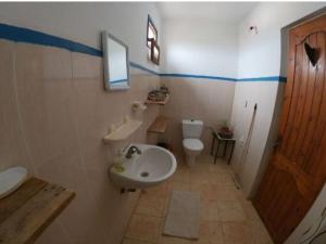 a bathroom with a white sink and a toilet at Hippie Chic House in Sidi Kaouki