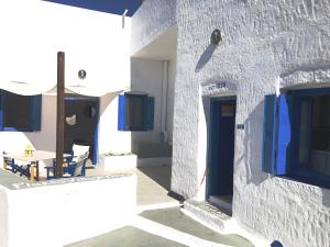 FiropótamosにあるThe Nestの青い扉とテーブルのある白い建物