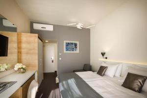 Ein Bett oder Betten in einem Zimmer der Unterkunft Remisens Hotel Albatros-All inclusive