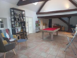 a living room with a ping pong table and chairs at COUL'Ô'BERGE in Coulanges-lès-Nevers