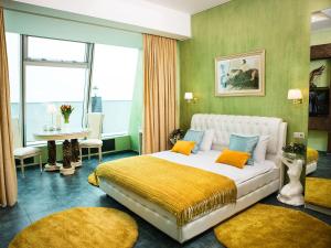 a bedroom with a large bed with yellow and blue pillows at Imperia City in Moscow