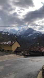 a view of a mountain range with snow covered roofs at La Forna in Caso