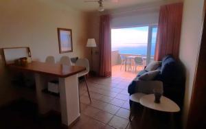 a living room with a couch and a table at La Muralla Apartamentos in Puerto Naos