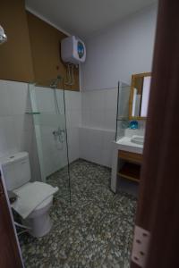 a bathroom with a toilet and a sink at Bella Vista Premium Homestay in Banyuwangi