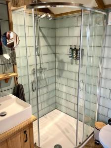 a bathroom with a shower and a sink at The Walnut Wagon in the heart of Mells. in Frome