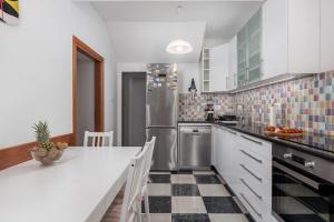 a kitchen with a refrigerator and a counter top at Apartment Thor in Opatija +13 photos