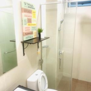 a bathroom with a toilet and a glass shower at Atlantis Residence#3409#1Bedroom#2-4Pax# in Melaka