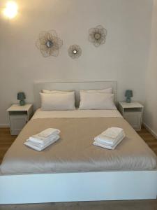 a bedroom with a large bed with two night stands at Casetta Marconi Trentotto in Rome