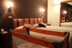 Ένα ή περισσότερα κρεβάτια σε δωμάτιο στο Hotel Palacio Dos Olivos