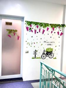 a door with flowers and a bike on it at THE JOYS HOSTEL in Ho Chi Minh City