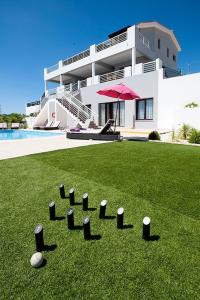 a bunch of balls in the grass in front of a house at Villa Arcadia, Kallepia in Paphos