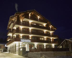 a tall building with lights on it at night at The Capra Saas-Fee in Saas-Fee