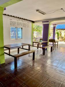 a group of benches in a room with windows at Happiness Guesthouse in Koh Rong Sanloem