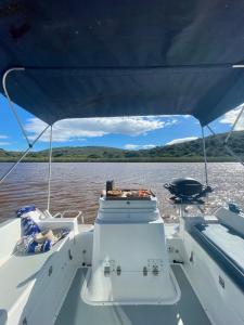 a view from the back of a boat on the water at Houseboats - Living The Breede - Valid Skippers License compulsory in Malgas