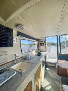 uma cozinha num trailer com um lavatório em Houseboats - Living The Breede - Valid Skippers License compulsory em Malgas