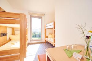 a room with two bunk beds and a desk at Bielefeld JBB Jugendgästehaus in Bielefeld