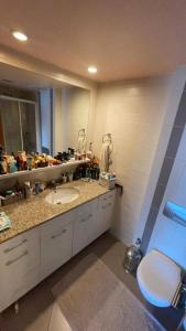 a bathroom with a sink and a mirror at Luxe Residence next to Water Garden Open Mall, International Financial Center & Medical Center in Istanbul