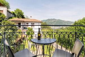 a table with a bottle of wine on a balcony at Garibaldi's Apartment in Como