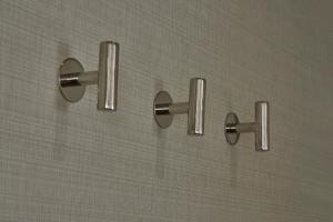 a shower with four silver knobs on a wall at Delta Hotels by Marriott Toronto Airport & Conference Centre in Toronto
