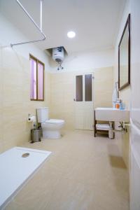 a bathroom with a toilet and a sink and a tub at Lantern Stay in Marsalforn