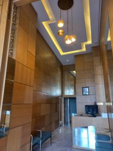 a conference room with a wooden wall with a table and chairs at Maarif Home Casablanca in Casablanca