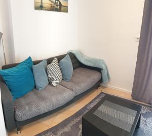 a couch with pillows on it in a living room at Blue Star Apartments in Dubrovnik