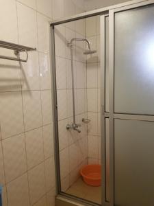 a bathroom with a shower with a toilet in it at Good neighborhood and people around in Kampala