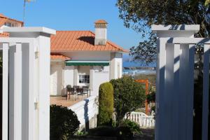 a white house with a white fence at finca dos Mares in Ferrol