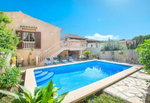 a swimming pool in the backyard of a house at Owl Booking Villa Irina - 2 Min Walk To The Old Town in Pollença