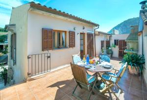 a patio with a table and chairs on a patio at Owl Booking Villa Irina - 2 Min Walk To The Old Town in Pollença