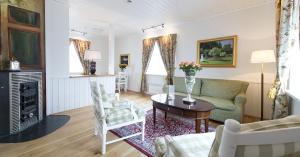 a living room with a couch and a table at Hovde Gård in Brekstad