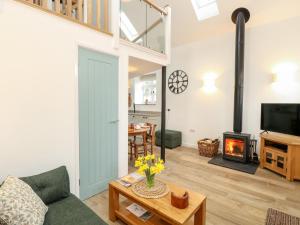a living room with a green door and a fireplace at Wensum Spring in Whissonsett