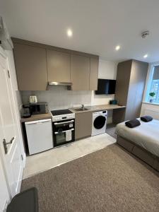 a small kitchen with a bed in a room at Bright Modern, 1 Bed Flat, 15 Mins Away From Central London in Hendon