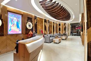 a lobby with couches and chairs in a building at Aman International-A New Unit of Aman Continental in New Delhi