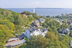 an aerial view of a house on a hill next to the water at moderne Ferienwohnung mit Balkon, Meerblick - Ferienresidenz Zwei BoddenFeWo 1-5 in Lietzow