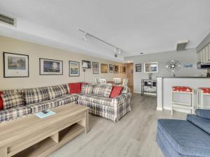 a living room with two couches and a table at 106 Edgewater Inn in Charlevoix