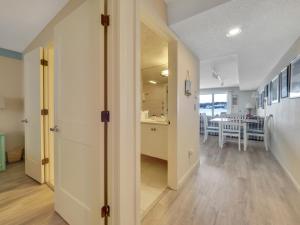 a hallway with a kitchen and a dining room at 106 Edgewater Inn in Charlevoix