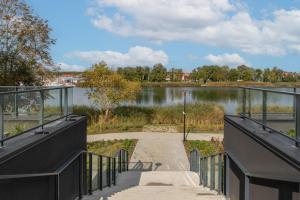 a bridge over a river with a body of water at Wellness & SPA Resort Aquamarine Apartment by Renters in Dziwnów