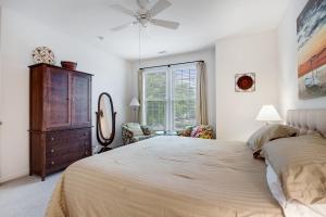 a bedroom with a bed and a dresser and a window at Bear Trap Dunes 53D Willow Oak Ave in Ocean View +30 photos