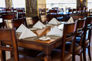 a wooden table with white napkins on it in a restaurant at The RN Hotels in Wadi Musa