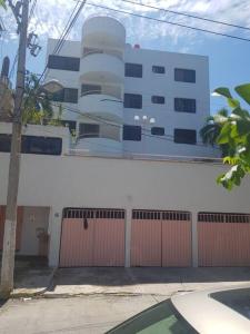 a building with a gate and a fence in front of it at Departamento en Zona Dorada de Acapulco in Acapulco