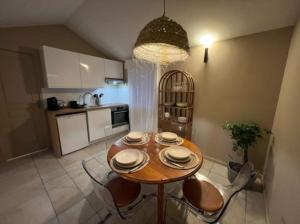 a kitchen with a wooden table and chairs in a kitchen at Casa Melodia in Pontoise